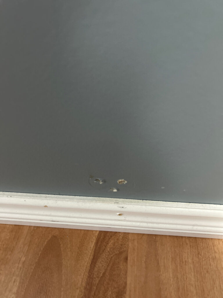 Drywall holes in baseboard